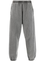 Acne Studios pantalon de jogging à bords frangés - Gris