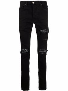 AMIRI jean skinny à finitions effilochées - Noir