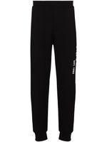 Alexander McQueen pantalon de jogging à imprimé graffiti - Noir