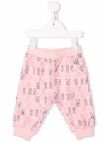 Moschino Kids pantalon à imprimé monogrammé - Rose