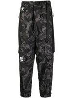 AAPE BY *A BATHING APE® pantalon fuselé à imprimé camouflage - Noir