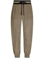 Dolce & Gabbana pantalon en soie à motif monogrammé - Tons neutres