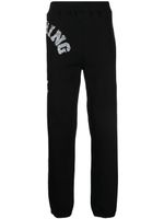 A BATHING APE® pantalon de jogging à logo imprimé - Noir