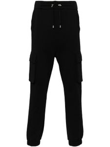 Balmain pantalon de jogging à logo imprimé - Noir