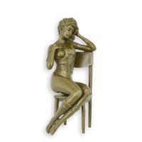 A BRONZE SCULPTURE OF A WOMAN ON A CHAIR