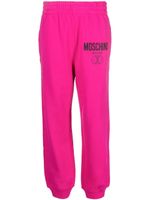 Moschino pantalon de jogging à logo imprimé - Rose